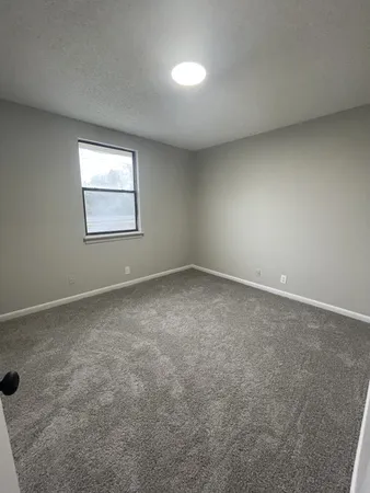 an empty room with a empty space and windows