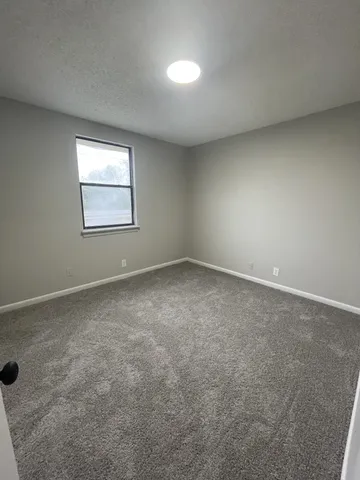 an empty room with a empty space and windows