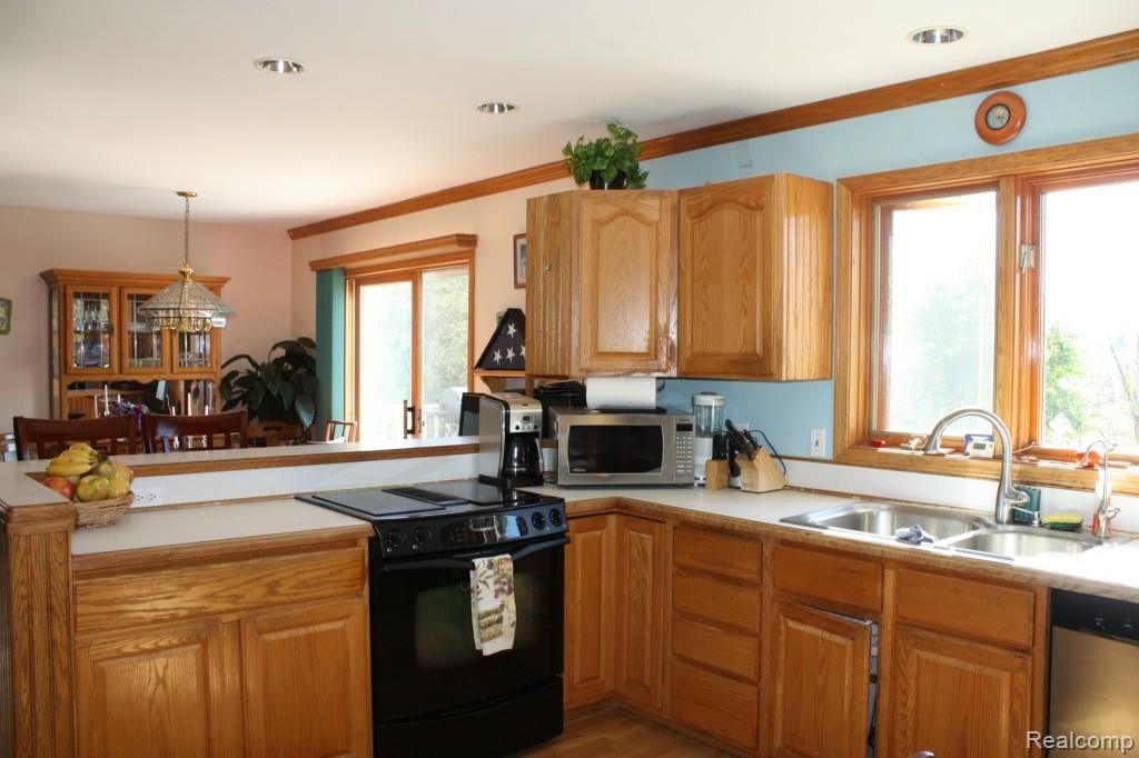 5067 Mason Road Howell, MI 48843 - Photo 6 of 43 kitchen overlooks dining room with doorwall to deck