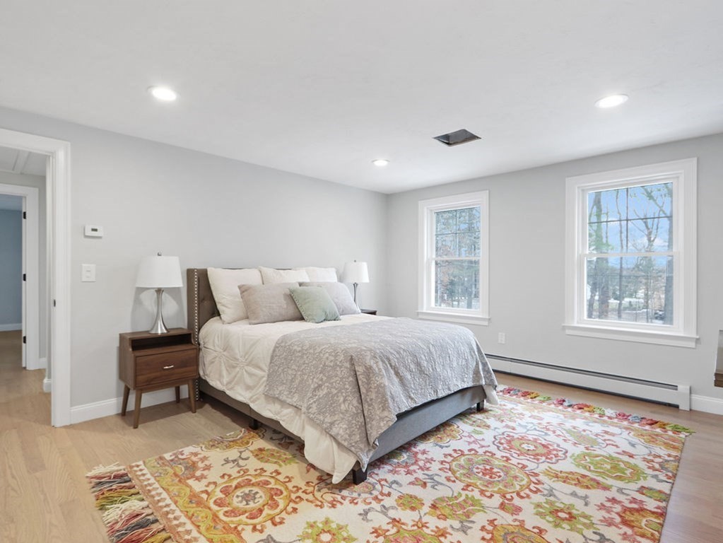 19 Crest Road Natick, MA 01760 - Photo 17 of 40 a spacious bedroom with a large bed and a window
