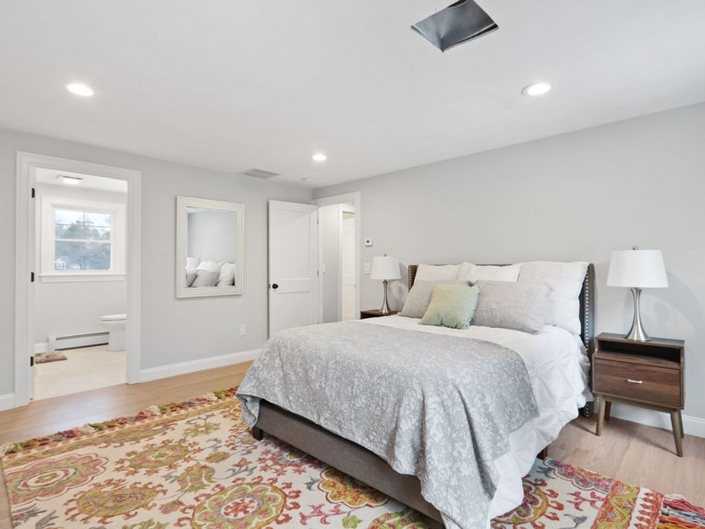 19 Crest Road Natick, MA 01760 - Photo 19 of 40 a spacious bedroom with a bed and wooden floor