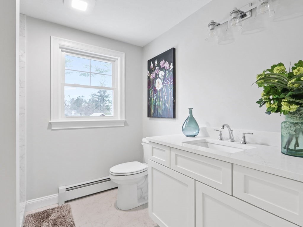 19 Crest Road Natick, MA 01760 - Photo 21 of 40 a bathroom with a toilet sink and mirror