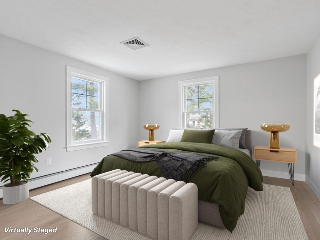 19 Crest Road Natick, MA 01760 - Photo 23 of 40 a bedroom with a large bed and potted plant with two window