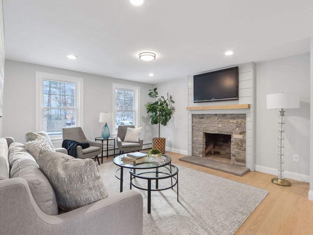 19 Crest Road Natick, MA 01760 - Photo 5 of 40 a living room with furniture a fireplace and a flat screen tv