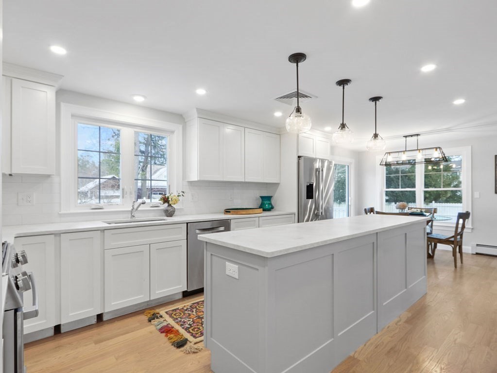 19 Crest Road Natick, MA 01760 - Photo 6 of 40 a kitchen with kitchen island a sink a stove a center island and a window