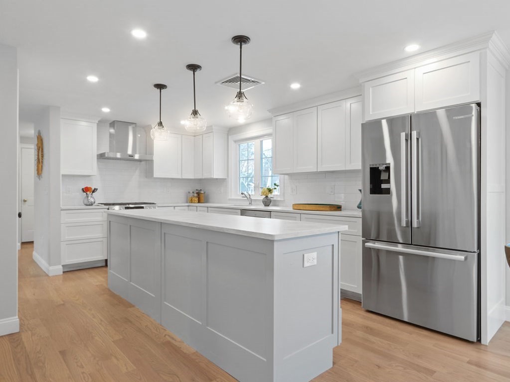 19 Crest Road Natick, MA 01760 - Photo 10 of 40 a kitchen with stainless steel appliances granite countertop a refrigerator a sink dishwasher a stove and white cabinets with wooden floor