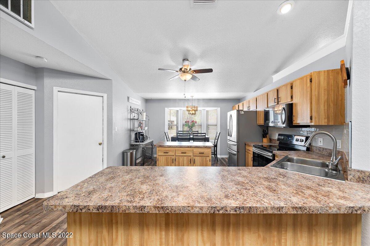 6165 Corning Road Cocoa, FL 32927 - Photo 13 of 44 a view of a living room and kitchen