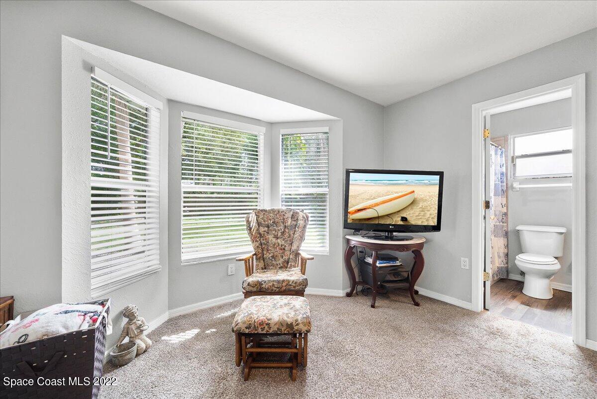 6165 Corning Road Cocoa, FL 32927 - Photo 16 of 44 a living room with furniture and a flat screen tv