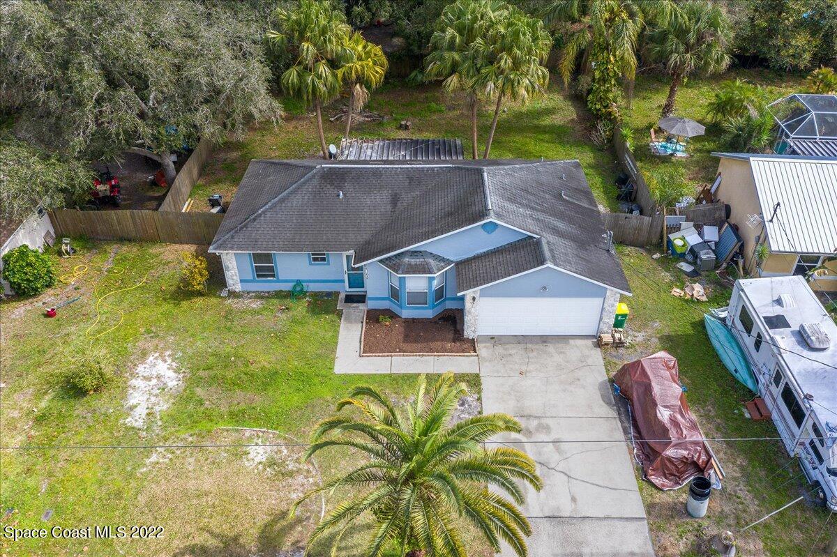 6165 Corning Road Cocoa, FL 32927 - Photo 29 of 44 an aerial view of a house with garden space and swimming pool