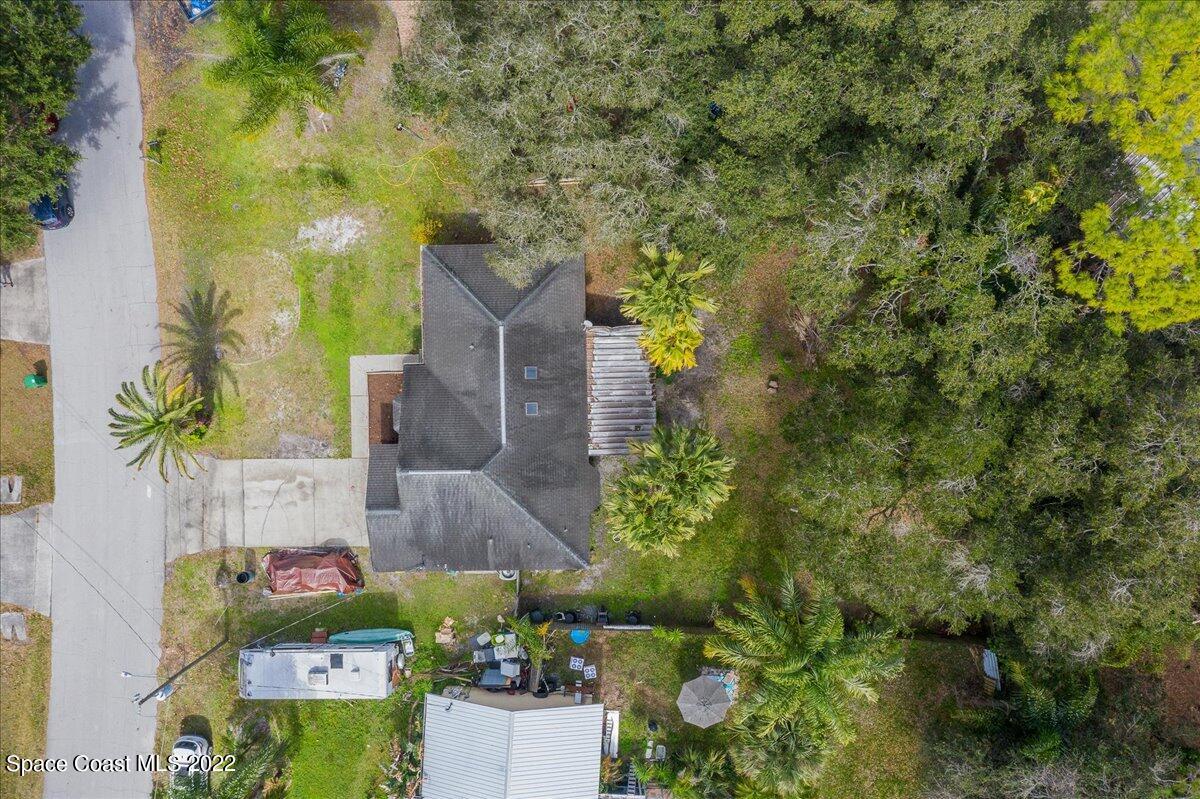 6165 Corning Road Cocoa, FL 32927 - Photo 32 of 44 view of a house with a yard and garden