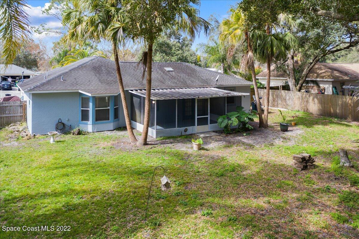 6165 Corning Road Cocoa, FL 32927 - Photo 33 of 44 a front view of house with yard and green space