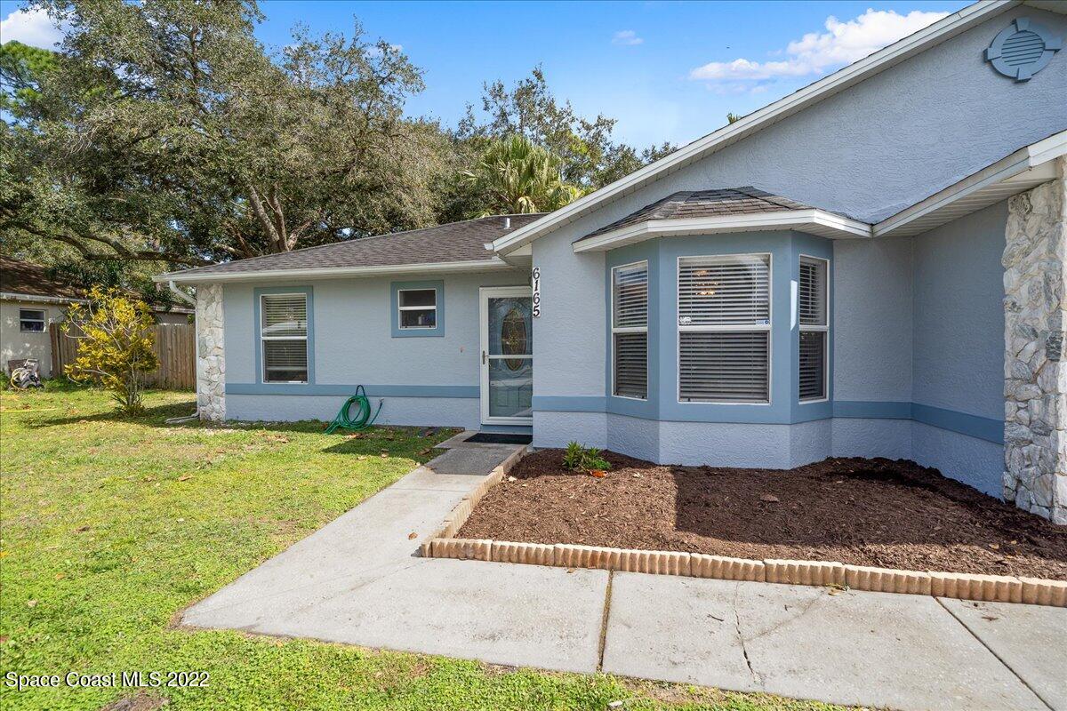 6165 Corning Road Cocoa, FL 32927 - Photo 4 of 44 a front view of a house with garden