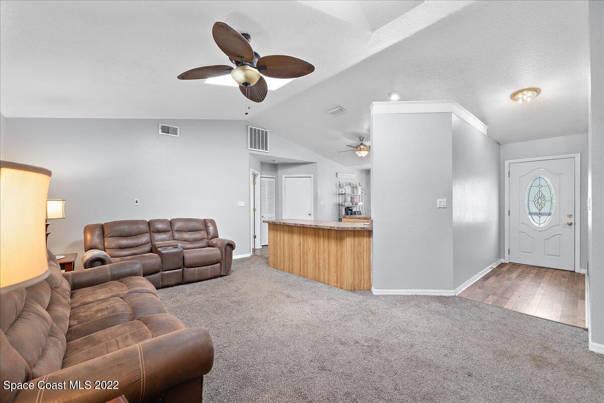 6165 Corning Road Cocoa, FL 32927 - Photo 5 of 44 a living room with furniture and kitchen view