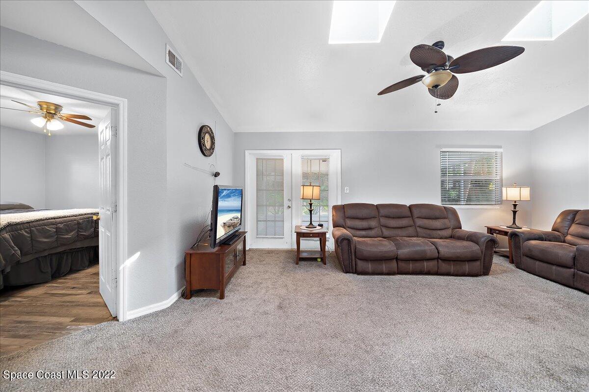 6165 Corning Road Cocoa, FL 32927 - Photo 6 of 44 a living room with furniture and a ceiling fan