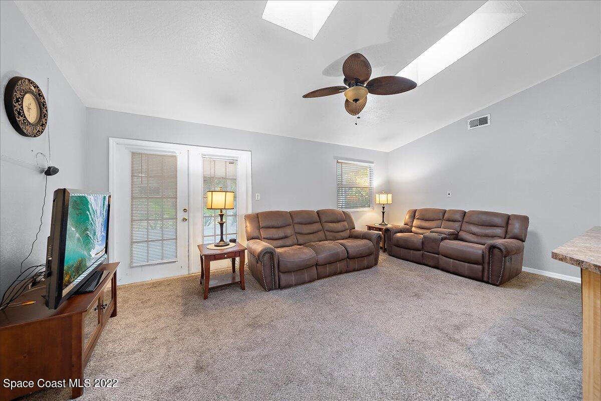 6165 Corning Road Cocoa, FL 32927 - Photo 7 of 44 a living room with furniture and a flat screen tv