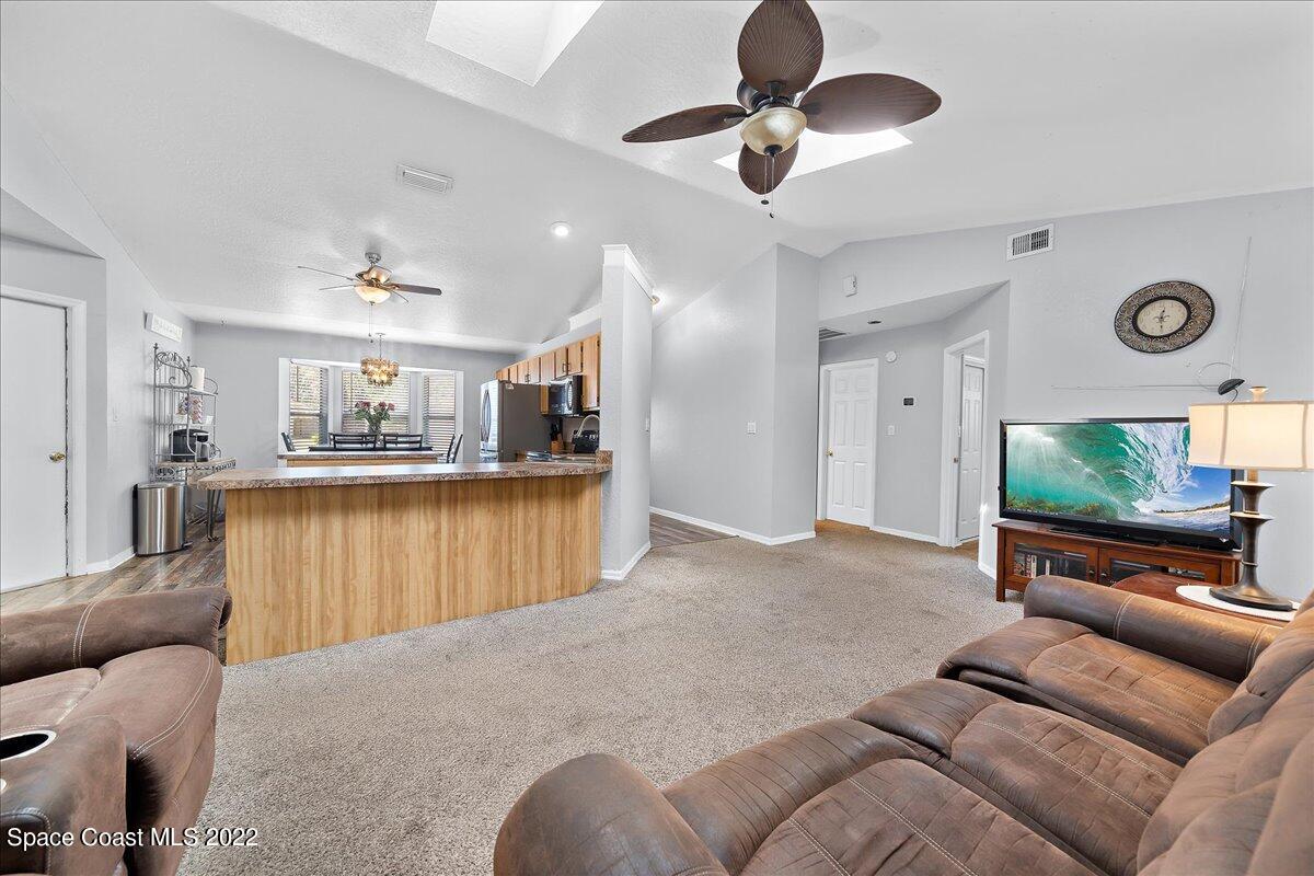 6165 Corning Road Cocoa, FL 32927 - Photo 9 of 44 a living room with furniture and a flat screen tv