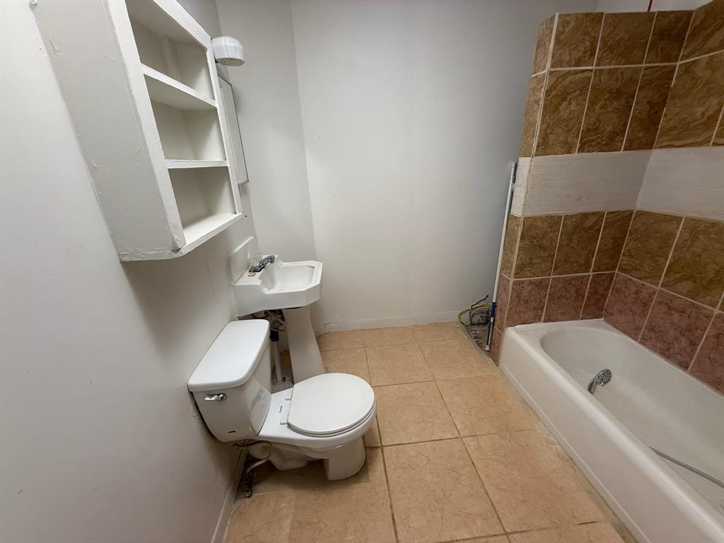 304 Neblett Street Eastland, TX 76448 - Photo 12 of 15 Bathroom with baseboards and light tile patterned floors