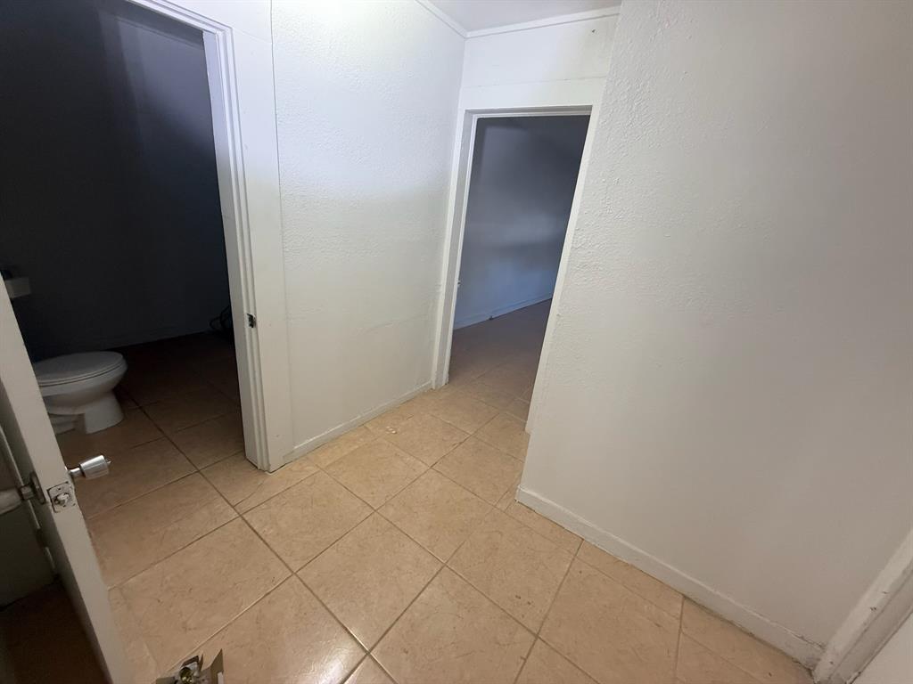 304 Neblett Street Eastland, TX 76448 - Photo 6 of 15 Hall featuring light tile patterned floors