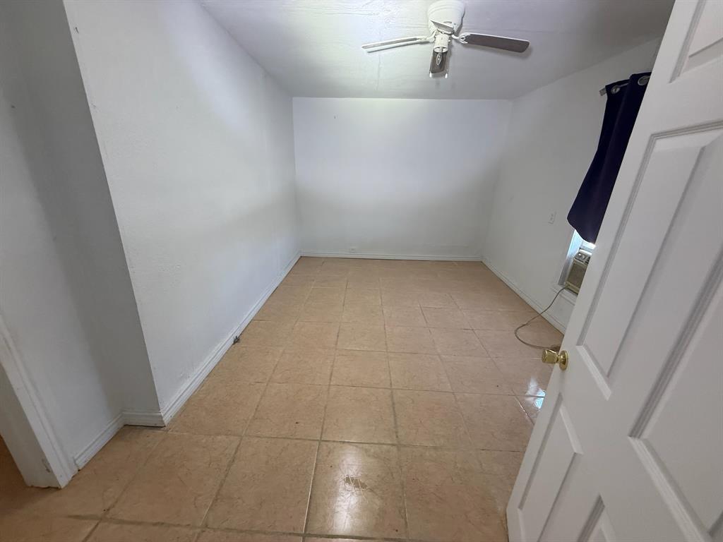 304 Neblett Street Eastland, TX 76448 - Photo 10 of 15 Spare room featuring ceiling fan and baseboards
