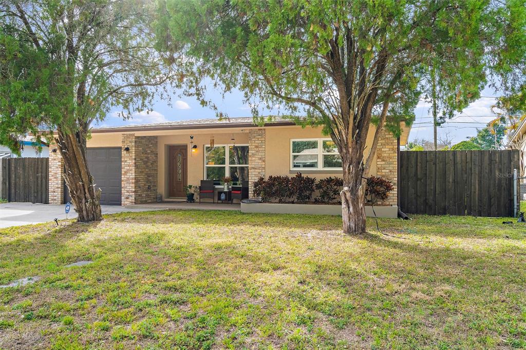 1950 Albany Drive Clearwater, FL 33763 - Photo 1 of 26 a view of a house with a yard and large tree