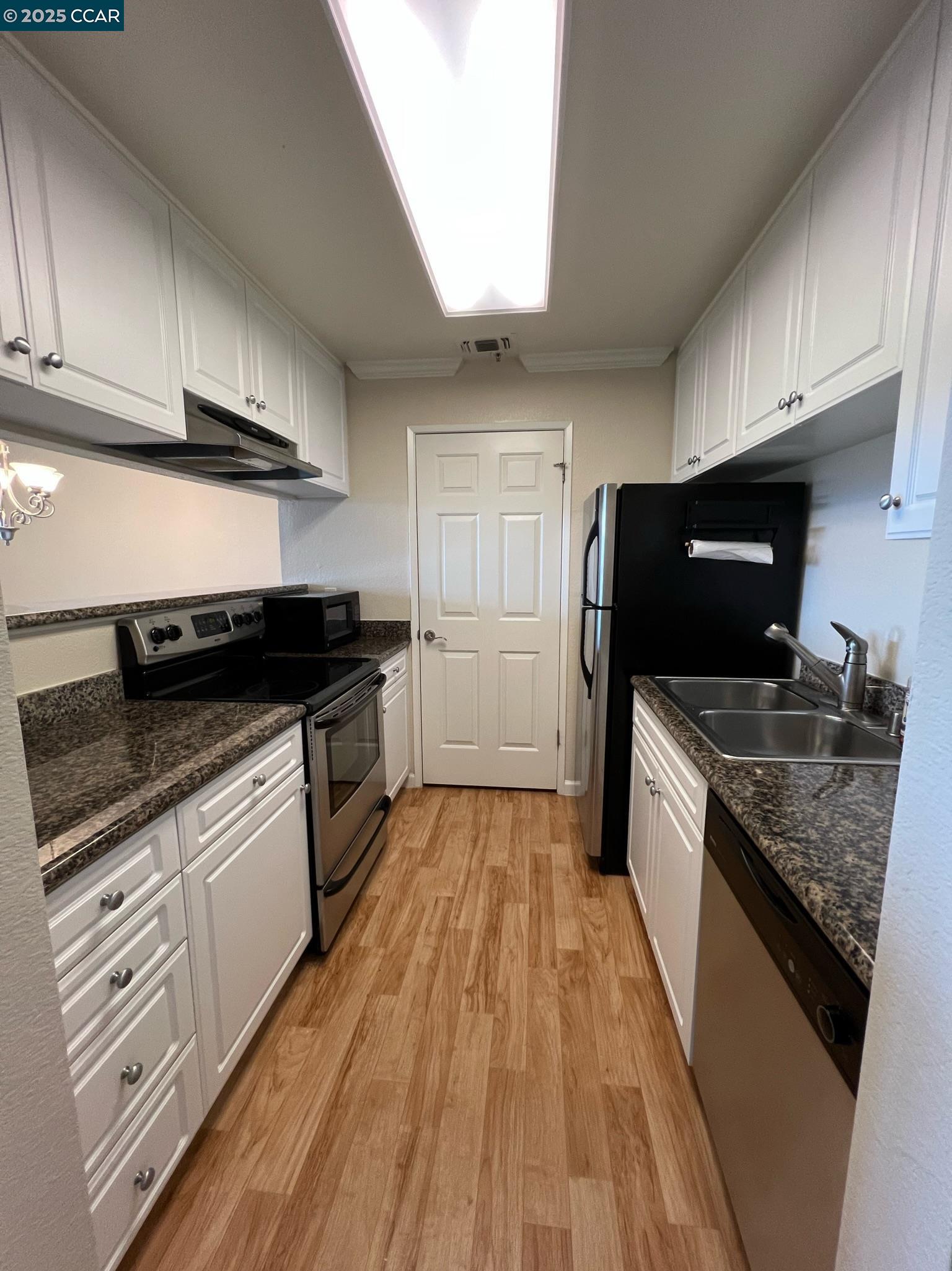 460 Bollinger Canyon Lane, Unit 286 San Ramon, CA 94582 - Photo 5 of 14 a kitchen with granite countertop stainless steel appliances a sink stove top oven and cabinets