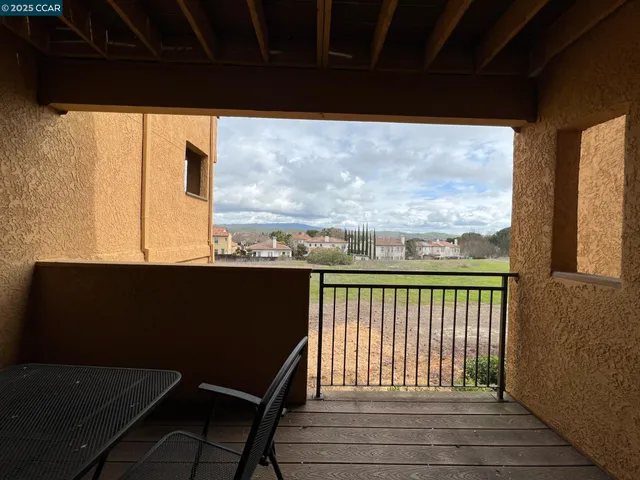 a view of balcony with wooden floor and outdoor seating