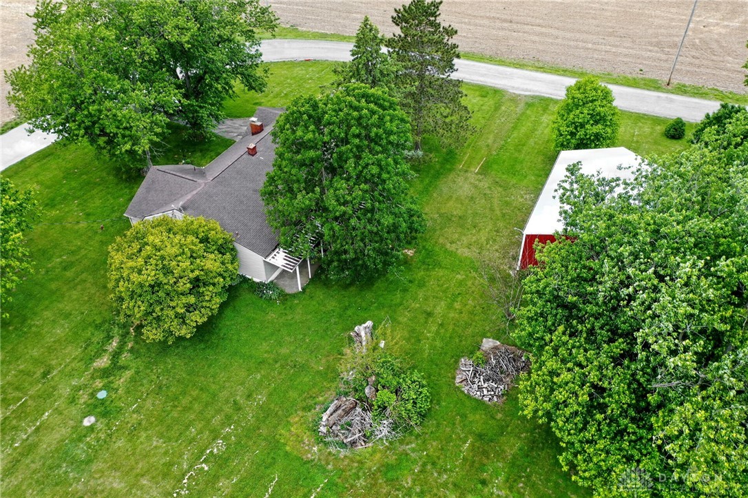 2470 Clark Run Road Xenia, OH 45385 - Photo 55 of 57 This verdant property features a charming home and a classic barn, nestled amidst lush greenery.
