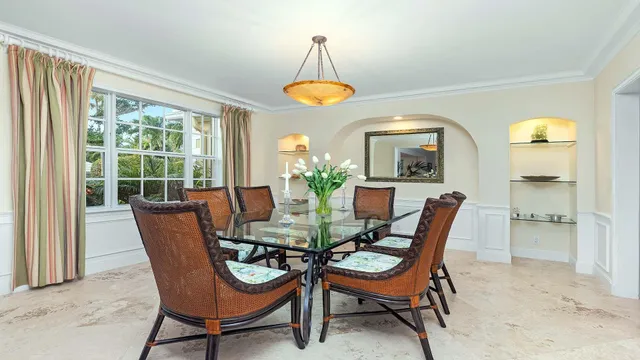 a kitchen with cabinets and chairs