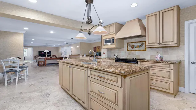 a bathroom with a granite countertop sink a mirror and a shower