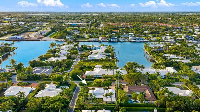 an aerial view of residential houses with outdoor space and lake view