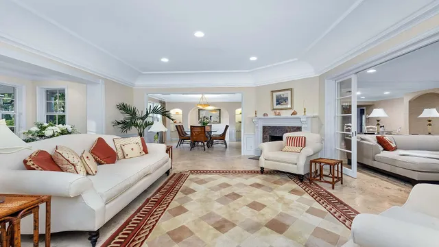 a living room with furniture wooden floor and a view of kitchen