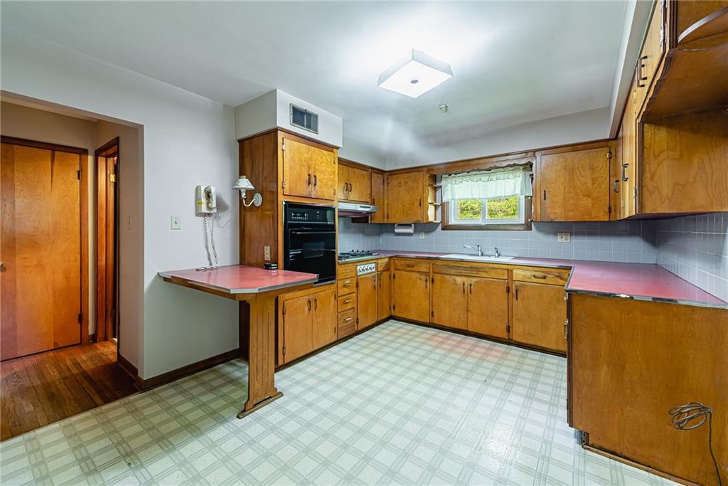 520 North 9th Street Indiana, PA 15701 - Photo 13 of 29 a kitchen with stainless steel appliances granite countertop a sink a stove and a refrigerator