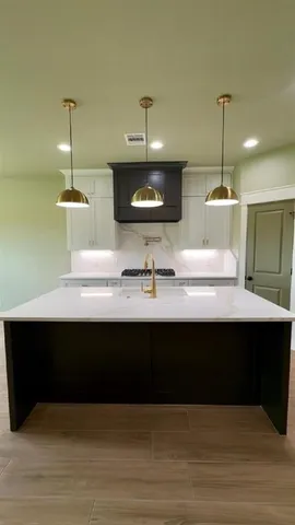 a kitchen with a sink and a mirror