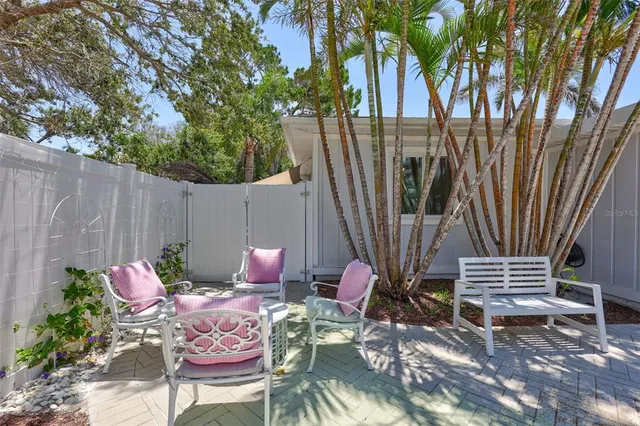 a backyard of a house with table and chairs