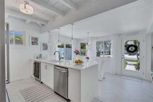 a kitchen with stainless steel appliances a sink stove and cabinets