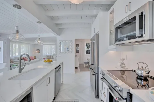 a kitchen with stainless steel appliances granite countertop a sink and stove