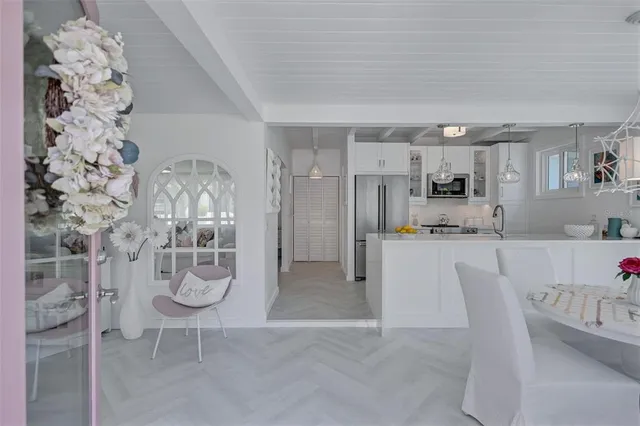 a kitchen with stainless steel appliances a refrigerator and cabinets