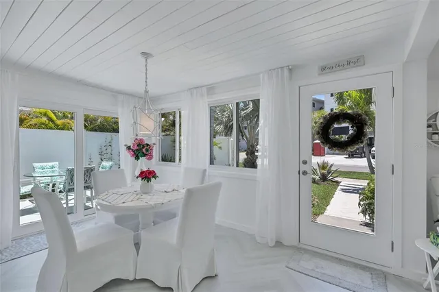 a view of a dining room with furniture and chandelier
