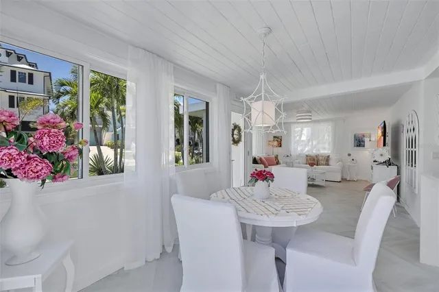 a living room with furniture and flowers