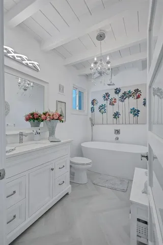 a bathroom with a sink vanity mirror and toilet