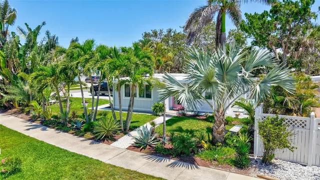 a green field with lots of trees in front of it