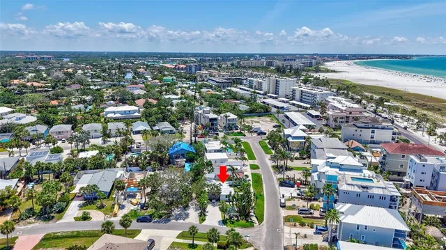 an aerial view of residential houses with outdoor space and ocean view