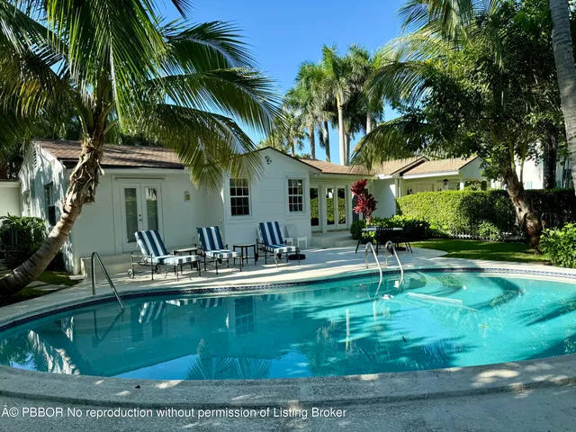 a house view with swimming pool and garden