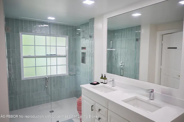 a bathroom with a sink double vanity and shower