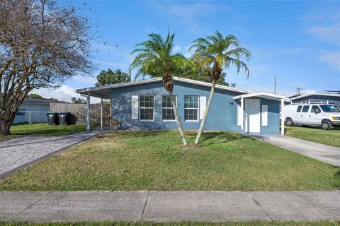 a front view of a house with a garden and plants