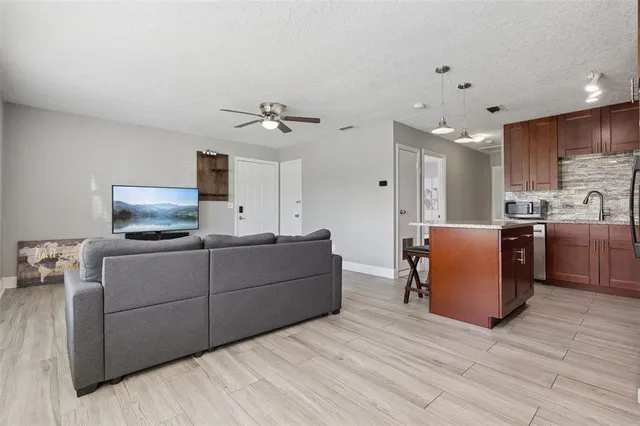 a living room with furniture and a wooden floor