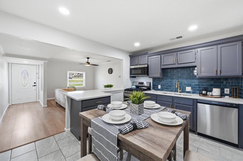 330 West Vinyard Road Duncanville, TX 75137 - Photo 5 of 20 a kitchen with a table and chairs in it