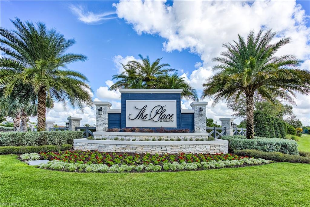 19576 The Pl Boulevard Estero, FL 33928 - Photo 2 of 35 a sign that is sitting in front of a house with a garden