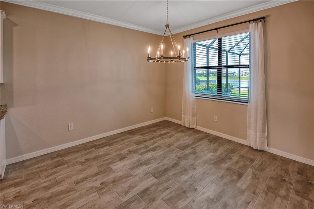 19576 The Pl Boulevard Estero, FL 33928 - Photo 8 of 35 a view of empty room with wooden floor and fan