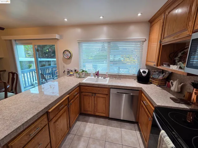 a kitchen with stainless steel appliances granite countertop sink stove top oven and cabinets